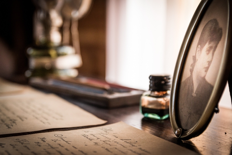 Letters, a photo of a woman and an ink bottle on a desk